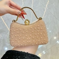 Elegant champagne pearl evening bag with gold metal handle and luxury wave texture - Champagne