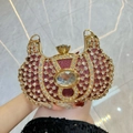Pochette de soirée en strass rouge et or avec un grand gemme central et finition luxe - Bordeaux