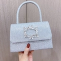 Detail view of silver glitter evening bag featuring a luxury rectangular rhinestone buckle - Silver