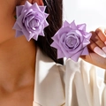 Detailed view of large 3D lavender purple rose floral earrings worn by a fashion model - Lavender