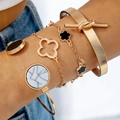 Bohemian gold bangle set with clover charms and marble stone on model's wrist - Gold Four Leaf Clover Bracelet Bangle 4-Piece Set (30762-bra-G-EP)