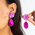 Detail shot of pink flower earrings with oval turquoise marble drop pendants worn by model - Rose Pink Purple