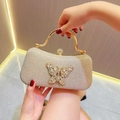 Detail of champagne gold glitter evening clutch with rhinestone butterfly and metal handle - Gold