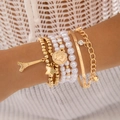 Dettaglio di bracciali a strati dorati con perle finte e ciondolo della Torre Eiffel - Stile Set Oro Pendente Torre Eiffel (5483-gold)
