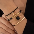 Detail of four-piece black beaded bracelet set with gold charms and star accents - Black Gold 4-Piece Set (28817-1-black)