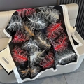 Detail of silk scarf with feather print and white satin border on beige leather sofa - Black