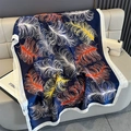 Close-up of lightweight silk scarf with vibrant feather prints on blue fabric - Navy Blue