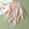 Detail of floral silk sun protection mask with adjustable ear loops on a green lawn - Pink - Reddish Brown Floral