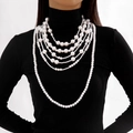 Close-up of elegant multi-layer faux pearl necklace draped over a black turtleneck - Luxury Multi-layer Graduated Artificial Pearl Necklace (28118-white)