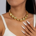 Primer plano de un collar de perlas grandes doradas con un acabado metálico brillante - Estilo de cuentas redondas grandes doradas (28282-gold)