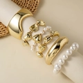 Detail of layered gold bangles and beaded bracelets with heart charm on a display - Wide Smooth Bangle Heart Pendant Set (30614-bra-G-EP)