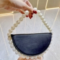 Detail of elegant black semi-circle clutch with large white pearl beaded handle - Black with White Pearl Handle