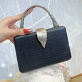 Luxury black snakeskin pattern evening clutch with silver spine handle and gold leaf clasp - Black