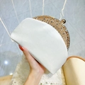 White satin clutch bag with gold rhinestone frame and spherical clasp held in hand - White