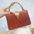 Luxury bronze red snakeskin textured evening clutch bag with gold leaf clasp and handle - Red