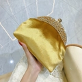 Elegant gold satin evening clutch bag with sparkling rhinestone metal frame and top clasp - Gold