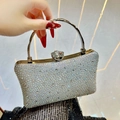 Sparkling silver rhinestone clutch with round metal handle and floral crystal clasp - Silver