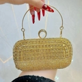 Elegant gold sparkling rhinestone clutch bag with a circular metal handle for evening gala - Gold