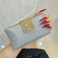Elegant silver glitter evening clutch bag with square crystal gold buckle in hand - Silver