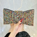 Handheld view of bow-shaped evening clutch bag with colorful rhinestones and crystals - Colorful