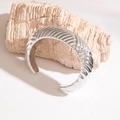 Close-up of silver-plated open bangle with elegant spiral wave texture on a stone base - Silver 3D Wave Texture Style (28753-2-silvery)