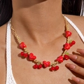 Close-up of gold chain necklace featuring red heart and cherry charms on a model - Shiny Red Heart Cherry Green Leaf Sweet Style (28704-red)