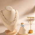 Detail of gold evil eye jewelry set with necklaces, bracelets and tassel accents - Evil Eye Blue White Beads Set (23146-suit-G)