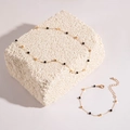 Detail of gold necklace and bracelet set with black cubic beads on white stone decor - Black Gold Minimalist Set (17034-3-silver black)