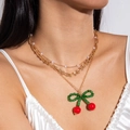 Detail of layered gold necklace featuring a handmade beaded red cherry pendant with bow - 3-Layer Layered Cherry Style (28935-G)