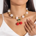Detailed close-up of acrylic beaded necklace featuring a red cherry pendant on model - Pearl Gold Bead Red Cherry (29001-G)