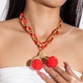 Close-up of red cherry pendant on chunky gold chain necklace with red satin ribbon - Red Ribbon Gold Chunky Chain Cherry (29025-red)