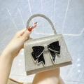 Elegant silver rhinestone evening bag with large black bow and sparkling handle - Gold