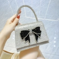 Elegant silver rhinestone evening bag with a large black crystal bow and top handle - Silver