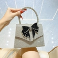 Silver rhinestone evening clutch with large black crystal butterfly bow detail - Silver