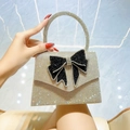 Silver rhinestone evening clutch bag with black swallowtail bow and round top handle - Gold