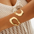 Detailed close-up of a polished gold metallic arm cuff with fluid organic curves - Golden Streamline Curve Style (29719-G)