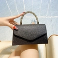 Sparkling black glitter clutch bag featuring a twisted silver rhinestone handle for parties - Black