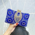 Royal blue luxury evening bag featuring floral rhinestones and gold peacock emblem - Blue