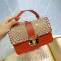 Elegant red leather handbag with sparkling rhinestones and golden hardware clasp - Burgundy