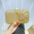 Sparkling gold sequin evening clutch bag with pleated detail and rhinestone flower - Gold