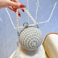 Spherical evening bag with faux pearls and rhinestones featuring a pearl top handle - Silver