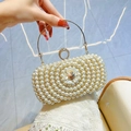 White pearl evening bag with golden ring handle and floral rhinestone clasp detail - Gold