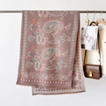 Detail of paisley pattern shawl with soft fringes styled in a luxury fashion setting - Paisley Dusky Pink