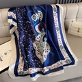 Detailed close-up of navy blue floral paisley silk scarf on white leather surface - Navy Blue (F-441)