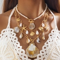 Close-up of bohemian layered necklace with golden starfish and sea shells on model - Multi-layer Gold Ocean Style Necklace (29284-G)