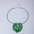 Statement necklace featuring a large translucent green acrylic monstera leaf on black cord - Monstera Leaf Style