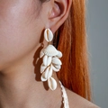Detail of natural seashell drop earrings featuring white cowrie shells on a female model - White Multi-Shell Tassel Style (29354-white)