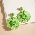 Detail view of handmade green raffia leaf earrings with woven texture on a white stone - Grass Green Sunflower (29362-green)