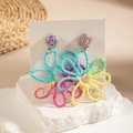 Macro view of multi-color woven raffia flower earrings on a natural stone surface - Rainbow Gradient Flower (29319-colour)