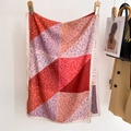 Summer silk scarf with red and pink color blocking and abstract floral patterns on a hanger - Medium-Long Style / Red Patchwork